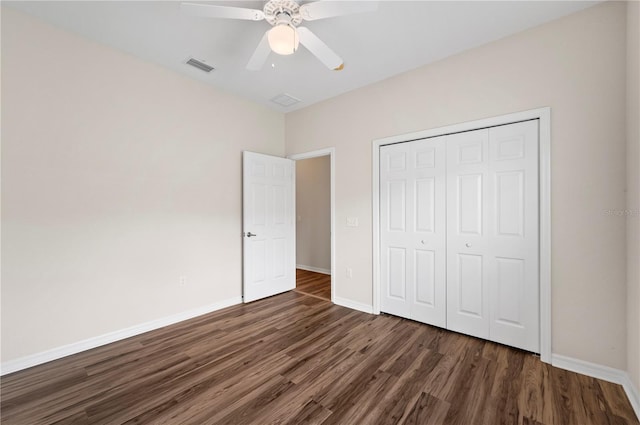 unfurnished bedroom with a closet, ceiling fan, and dark wood-type flooring