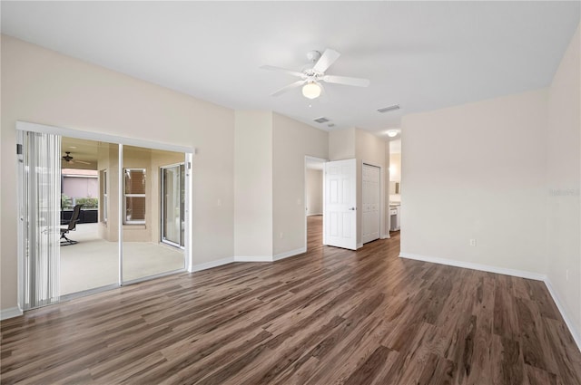 empty room featuring ceiling fan and dark hardwood / wood-style floors