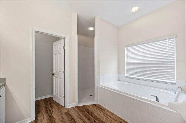 bathroom featuring separate shower and tub, vanity, and wood-type flooring