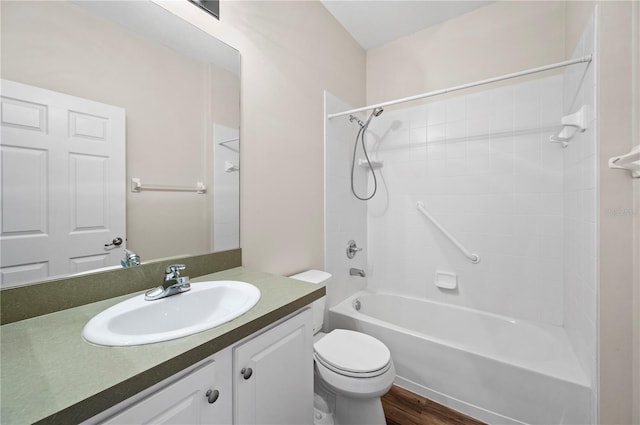 full bathroom with hardwood / wood-style flooring, vanity, shower / bathtub combination, and toilet