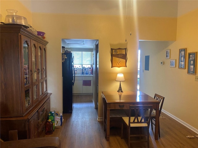 dining room featuring dark hardwood / wood-style flooring and sink