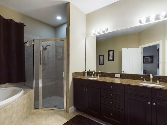 bathroom with tile patterned floors, vanity, and separate shower and tub