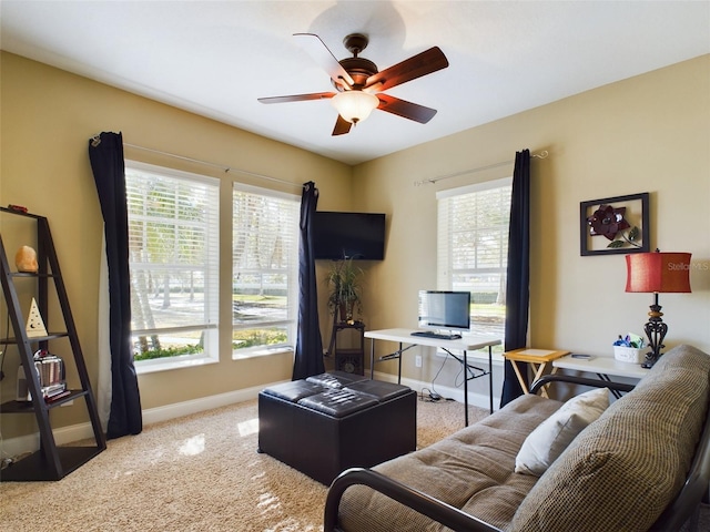 living room with carpet flooring, ceiling fan, and a wealth of natural light