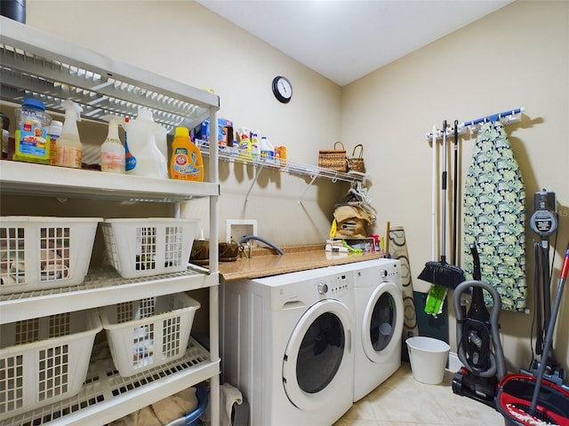 laundry room with separate washer and dryer and light tile patterned flooring