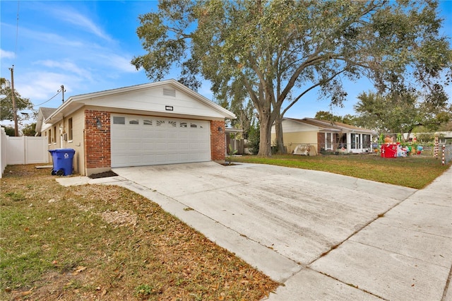 ranch-style home featuring a garage and a front yard