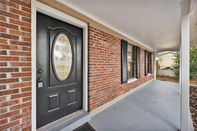 entrance to property featuring covered porch