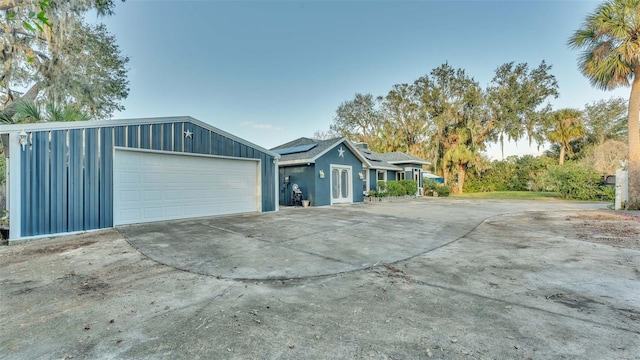 1769 S Lake Reedy Blvd, Frostproof, FL 33843 - view of property exterior with roof mounted solar panels and a garage