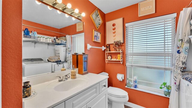 full bathroom with vanity, separate washer and dryer, shower / bath combination with curtain, and toilet