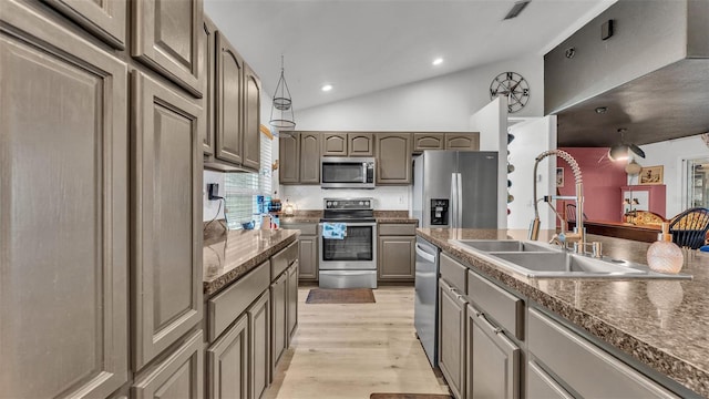 1769 S Lake Reedy Blvd, Frostproof, FL 33843 - kitchen with appliances with stainless steel finishes, lofted ceiling, light wood-style floors, dark countertops, and recessed lighting