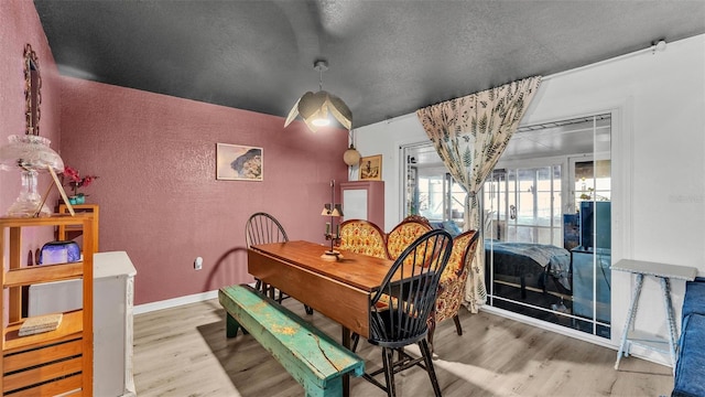 1769 S Lake Reedy Blvd, Frostproof, FL 33843 - dining area featuring wood finished floors, a textured wall, and a textured ceiling