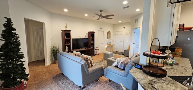 living area featuring light carpet, a ceiling fan, visible vents, and recessed lighting