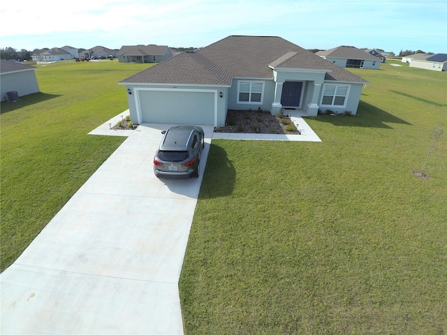 view of front of house with stucco siding, an attached garage, a residential view, driveway, and a front lawn