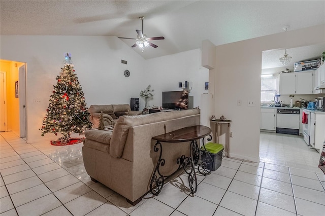 tiled living room with ceiling fan, a textured ceiling, and lofted ceiling