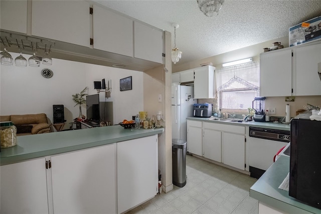 kitchen featuring a textured ceiling, sink, white cabinets, and white appliances