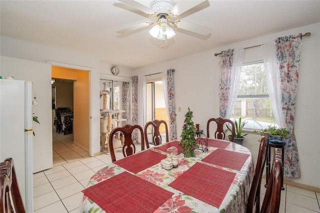 tiled dining space with ceiling fan