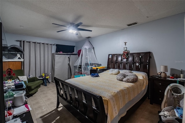 bedroom with ceiling fan and a textured ceiling