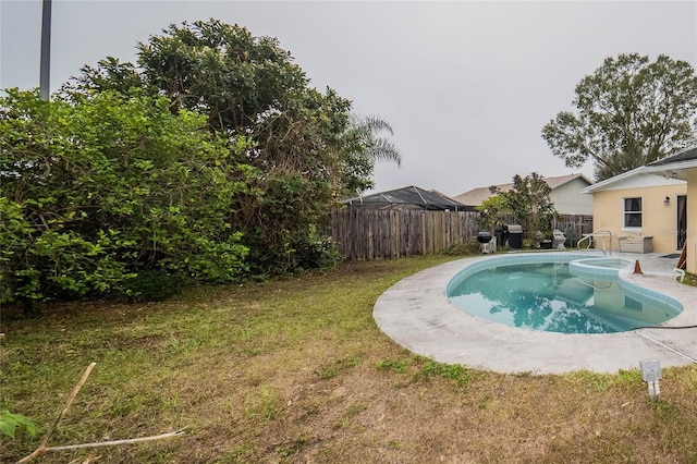 view of pool with a lawn