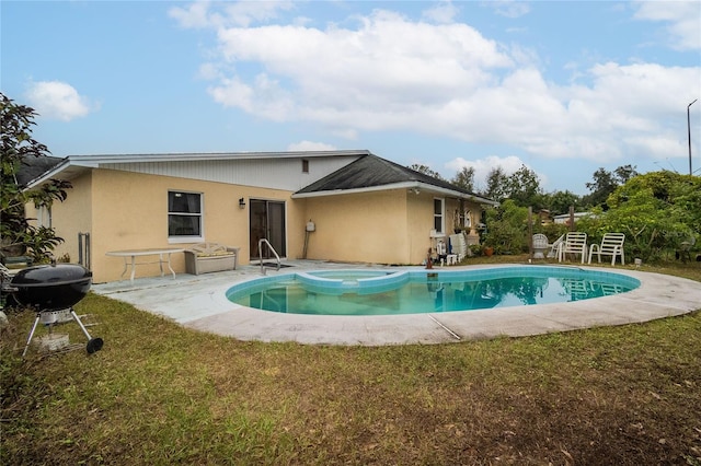 back of property featuring a patio area and a lawn