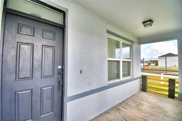 doorway to property featuring a porch