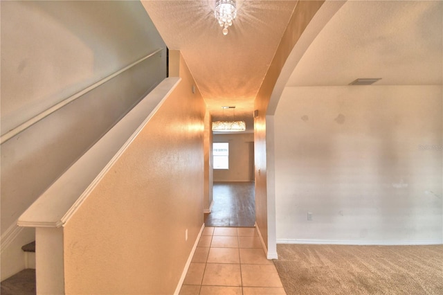 hall featuring light tile patterned floors