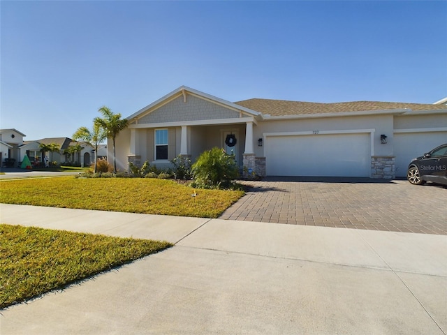 ranch-style home featuring a front lawn and a garage