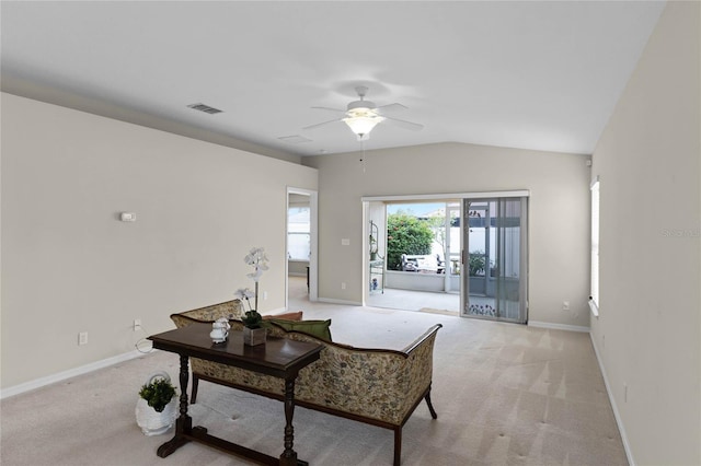 living room with ceiling fan, light colored carpet, and vaulted ceiling