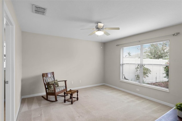 sitting room with light colored carpet and ceiling fan