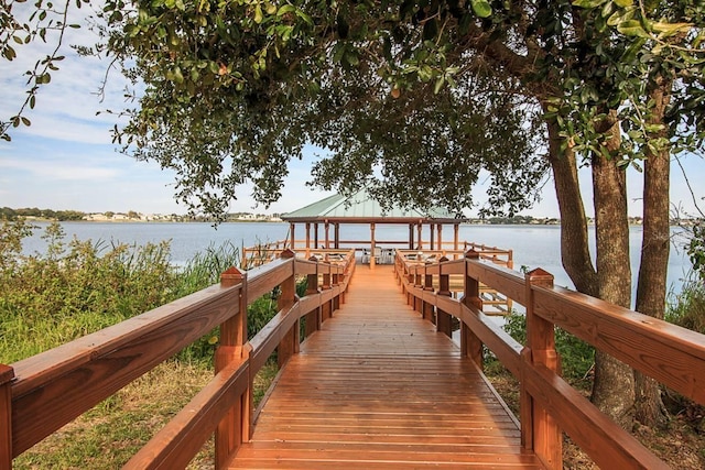 dock area with a gazebo and a water view