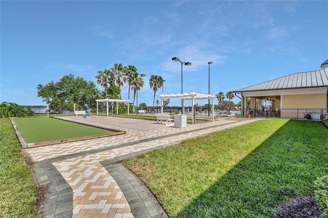 view of home's community featuring a yard and a pergola