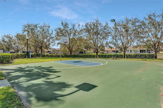 view of basketball court with a lawn