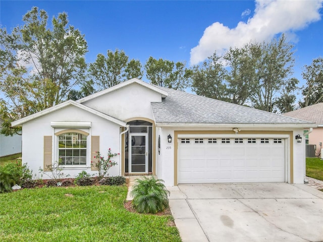 ranch-style house featuring a front lawn, central AC unit, and a garage