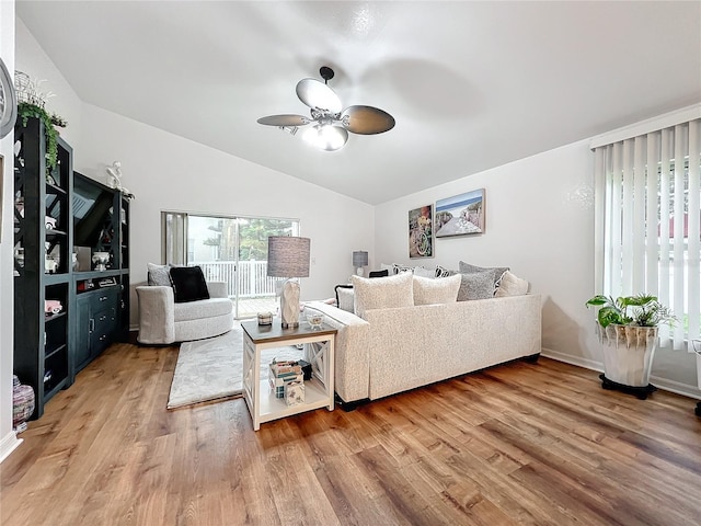 living room featuring ceiling fan, wood-type flooring, and lofted ceiling