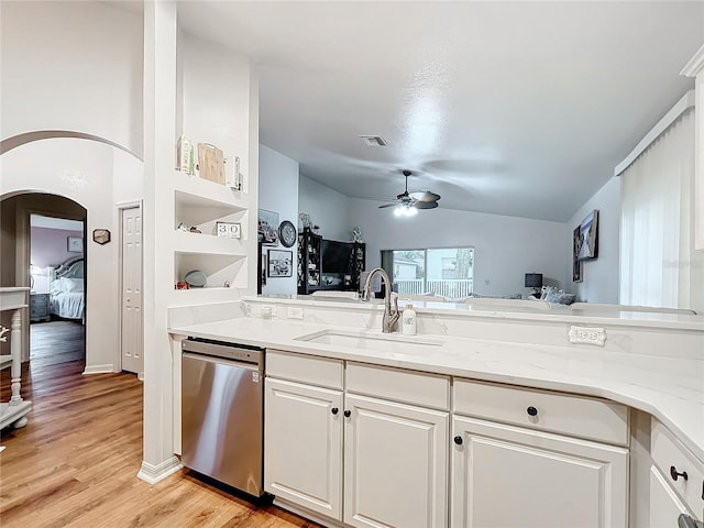 kitchen with dishwasher, white cabinets, sink, light stone countertops, and built in features