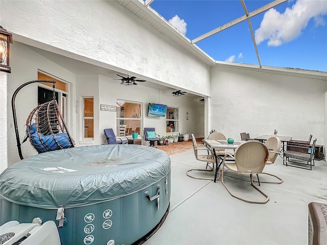 view of patio with ceiling fan and a lanai