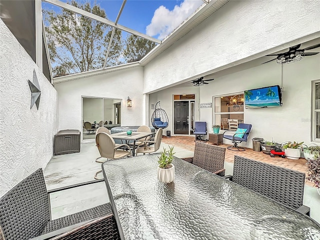 view of patio / terrace with ceiling fan and a lanai