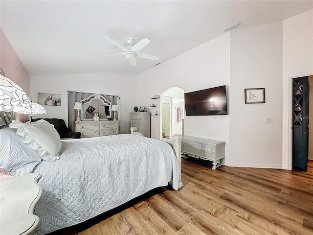 bedroom featuring ceiling fan, wood-type flooring, and vaulted ceiling