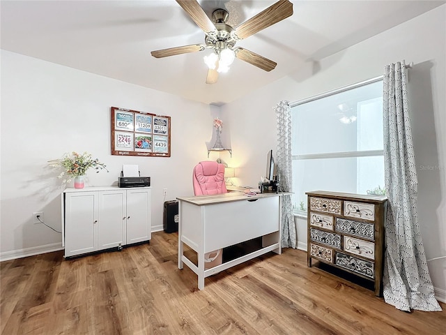 interior space with ceiling fan, light hardwood / wood-style floors, and white cabinetry