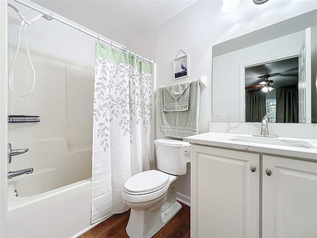 full bathroom with ceiling fan, hardwood / wood-style floors, shower / bath combination with curtain, toilet, and vanity