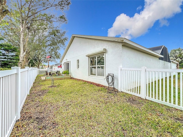 view of home's exterior with a yard