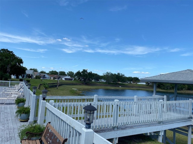 dock area featuring a gazebo and a deck with water view