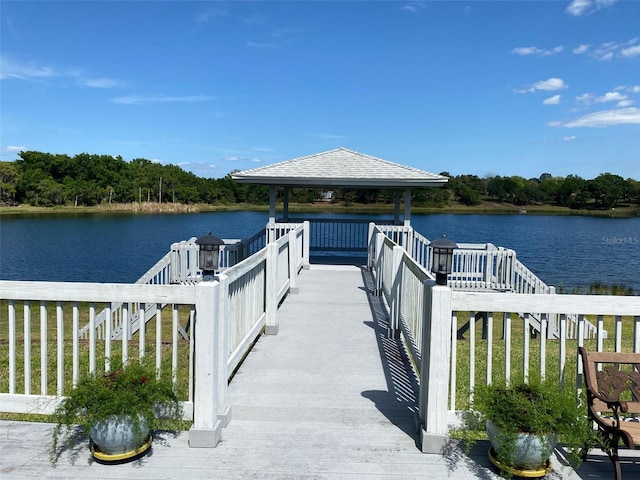 view of dock with a gazebo and a water view