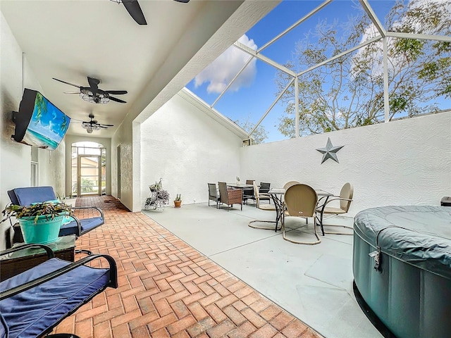 view of patio featuring glass enclosure and ceiling fan