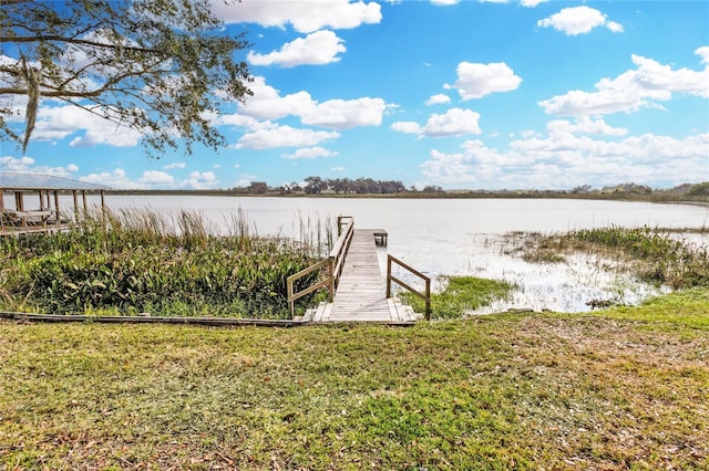 view of dock featuring a yard and a water view