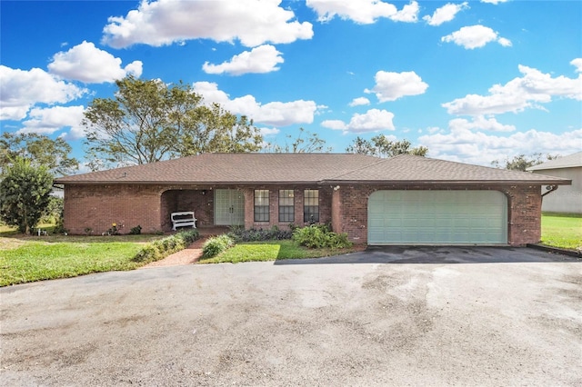 single story home featuring a front yard and a garage