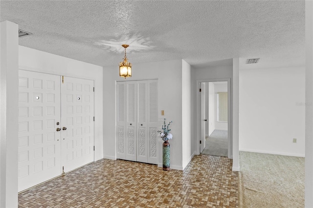 foyer featuring a textured ceiling