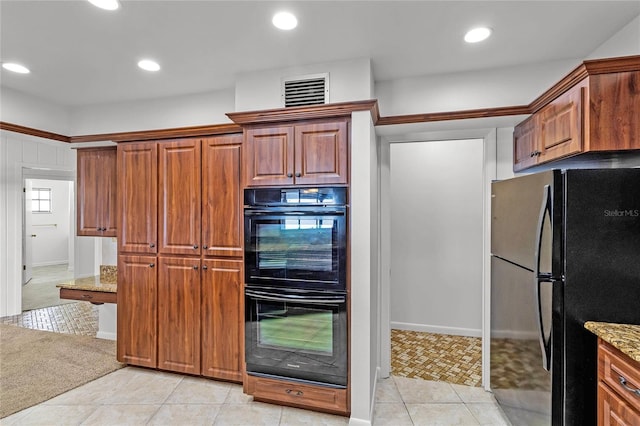 kitchen featuring light carpet, black appliances, and light stone counters