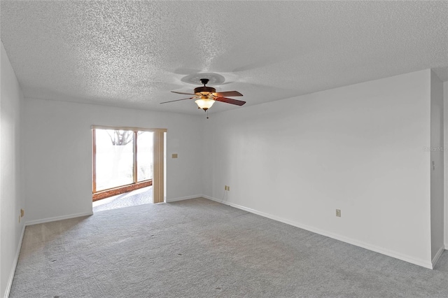 empty room with a textured ceiling, light carpet, and ceiling fan