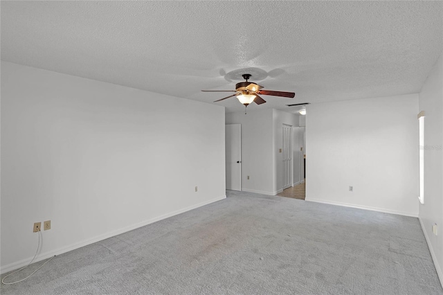 unfurnished room featuring ceiling fan, a textured ceiling, and carpet flooring