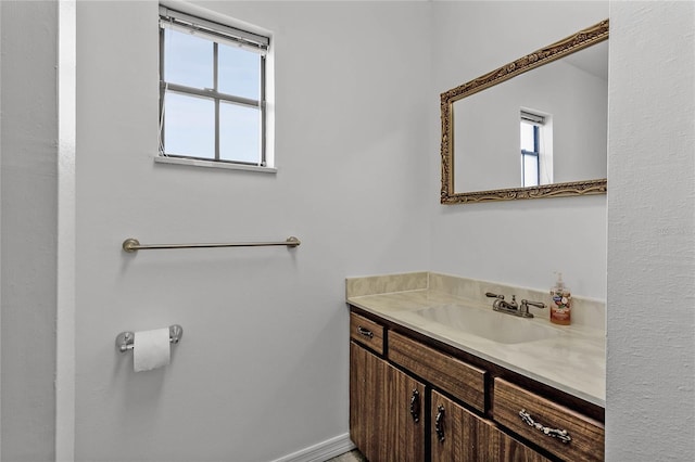 bathroom featuring a wealth of natural light and vanity