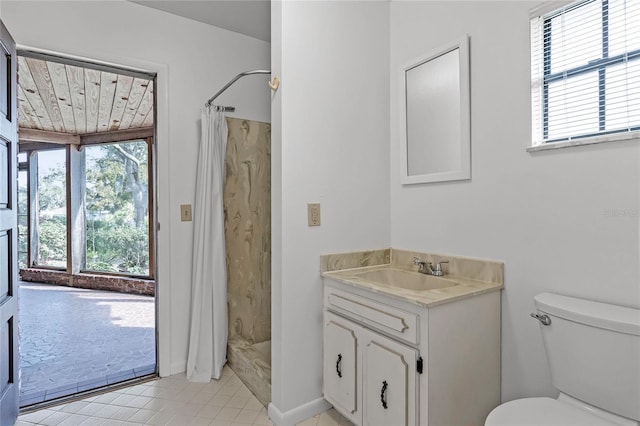 bathroom with curtained shower, tile patterned floors, vanity, and toilet